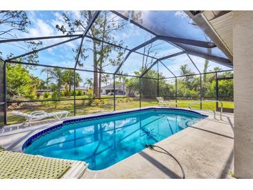 Enjoy a refreshing dip in this screened-in pool with beautiful outdoor views from the comfort of your own home at 1214 Rumson Ct, North Port, FL 34288