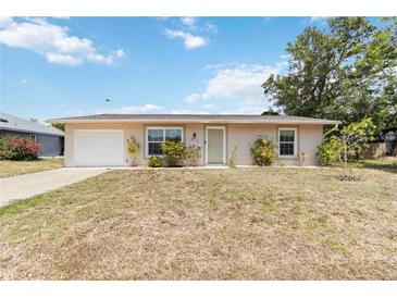 Charming single-story home featuring a well-maintained lawn, neutral stucco, and an attached one-car garage at 219 Capatola St, Port Charlotte, FL 33948