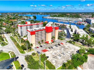 Stunning aerial view of a high-rise condo with a marina nearby, offering picturesque waterfront living at 232 Saint Augustine Ave # 701, Venice, FL 34285