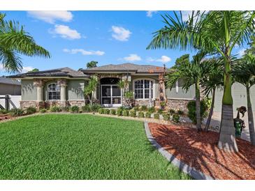 Charming single-story home with lush landscaping, stone accents, and a well-manicured lawn at 2769 Dode Ave, North Port, FL 34288