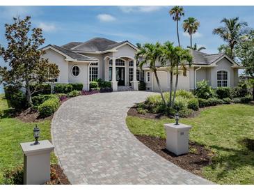 Beautiful home exterior featuring a circular driveway and lush landscaping at 333 Sunrise Dr, Nokomis, FL 34275