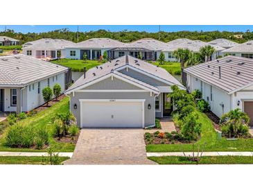 Charming single-story home with a two-car garage and beautifully landscaped front yard at 10367 Abaco Falls Dr, Englewood, FL 34223