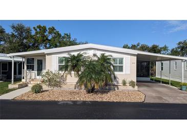 Charming single-story home featuring a covered carport and neat landscaping at 310 Tropic Dr, Osprey, FL 34229