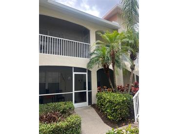Two story exterior elevation with a screened in entry way and screened in balcony at 7201 L Pavia Blvd # 7201, Venice, FL 34292