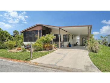 Charming single-story home with a covered carport and inviting screened-in porch at 763 Lakeside Dr, North Port, FL 34287