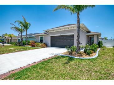 Well-maintained single-Gathering home with a two-car garage and lush landscaping at 137 Hercules Dr, Rotonda West, FL 33947