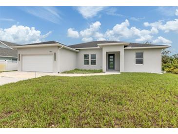Beautiful single-story home with manicured lawn and a two-car garage at 137 Mariner Ln, Rotonda West, FL 33947