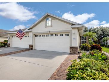 Charming home featuring a three car garage, manicured landscaping, and an inviting entrance at 29704 Niagara Court, Englewood, FL 34223