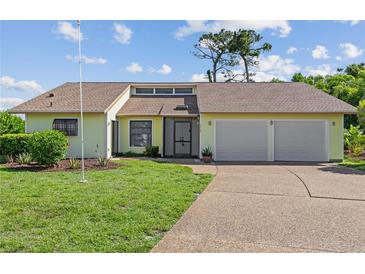 Charming single-story home with a well-maintained lawn, two-car garage, and inviting entrance at 1315 Pine Needle Rd, Venice, FL 34285