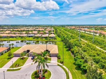 Beautiful aerial view of home, landscaping and community with waterway at 13913 Alafaya St, Venice, FL 34293