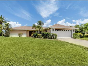 Charming single story home with an attached garage and mature landscaping at 1608 E Cypress Point Dr, Venice, FL 34293