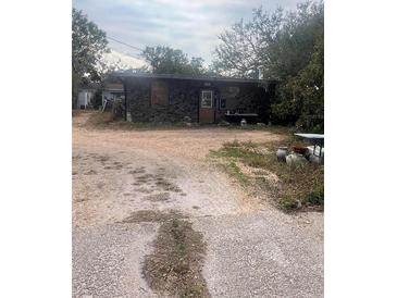 Single-story home with a distinctive stone facade and a modest, covered porch at 3010 17Th St, Sarasota, FL 34234