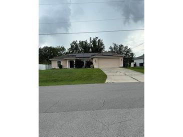 Charming single-story home featuring a two-car garage and solar panels for energy efficiency at 3601 Point St, North Port, FL 34286