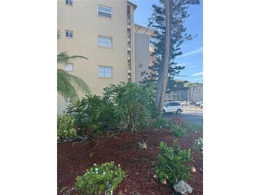 A beautiful view of the exterior of the building showing colorful plants and well maintained landscaping at 3697 Lake Bayshore Dr # H-109, Bradenton, FL 34205