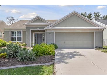 Charming single-story home featuring a well-maintained front yard and an attached two-car garage at 511 Wexford Dr, Venice, FL 34293