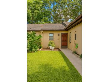 Inviting single-story home with a well-manicured lawn and charming front door entrance at 7201 Daiquiri Ln, Tampa, FL 33634