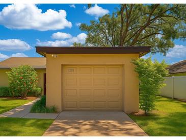 Attached one car garage with a brown door and house number under an extended roof at 7201 Daiquiri Ln, Tampa, FL 33634