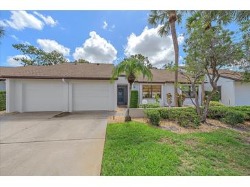 Charming single-story home with a well-manicured front yard, two-car garage, and inviting curb appeal at 1211 Capri Isles Blvd # 6, Venice, FL 34292