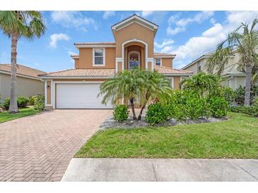 Inviting two-story home featuring a well-manicured lawn and a spacious two-car garage at 2146 Snapdragon Ln, Venice, FL 34292