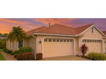 Charming one-story home featuring a two-car garage and beautifully landscaped front yard at 4343 Whispering Oaks Dr, North Port, FL 34287