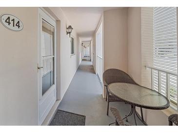 Long hallway with patio and exterior furniture near unit 414 at 437 Cerromar Ln # 414, Venice, FL 34293