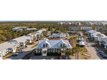 Scenic community featuring multiple buildings, a swimming pool, tennis court, parking, and lush landscaping at 6800 Placida Rd # 280, Englewood, FL 34224