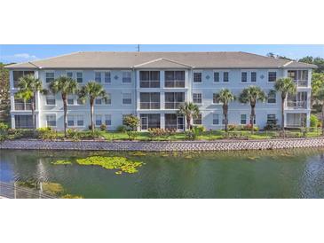 Charming three-story building with manicured landscaping and scenic water view at 700 Gardens Edge Dr # 722, Venice, FL 34285