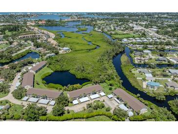 Beautiful aerial view of the community showcasing lush landscaping, waterways, and nearby amenities at 841 Waterside Dr # 202, Venice, FL 34285