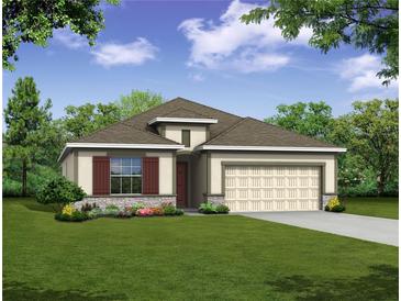 One-story home with attractive landscaping and a two-car garage at 25503 Calusa Dr, Punta Gorda, FL 33955