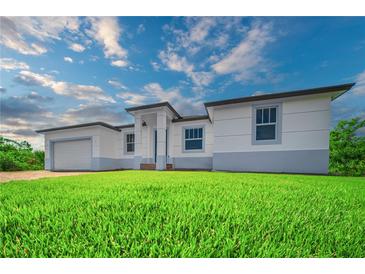 Well-manicured lawn and pleasing contemporary architecture highlight this charming single Gathering home at 15245 Brainbridge Circle, Port Charlotte, FL 33981