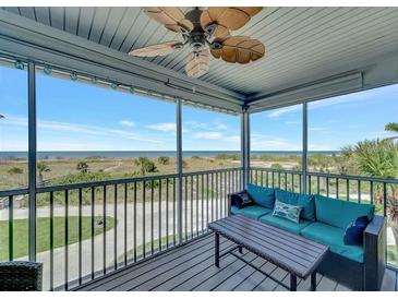 Enjoy the ocean view from this screened porch with a ceiling fan and comfortable seating at 7442 Palm Island Dr # 3624, Placida, FL 33946
