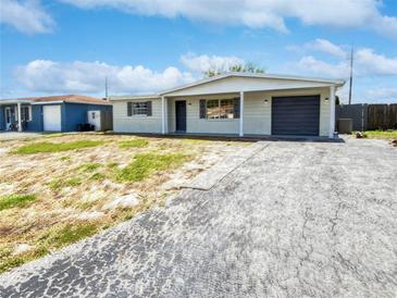 Newly renovated house with a gray garage door at 4102 Dalwood Dr, Holiday, FL 34691