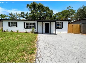 Charming single-story home with black trim, modern landscaping and a well-maintained lawn at 4011 Mesa Ave, Sarasota, FL 34233