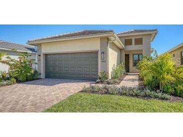 Attractive single-story house with a two-car garage and well-manicured lawn at 4915 Carova Way, Lakewood Ranch, FL 34211
