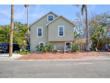 Charming two-story house with brick pavers and a lush, tropical landscape at 117 88Th Ave, Treasure Island, FL 33706