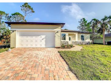Newly constructed home with a brick driveway and garage at 368 Munoz St, Port Charlotte, FL 33953