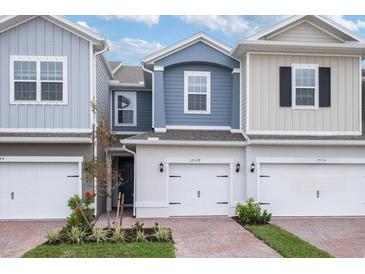 Three-unit townhome building with attractive brick pavers and landscaping at 17339 Peregrine Way, Punta Gorda, FL 33982