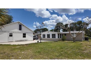 Spacious backyard with detached garage and sunroom at 1620 Lakeview Pl, Englewood, FL 34223