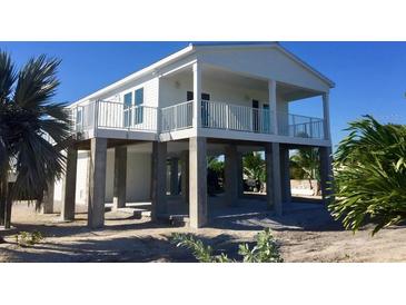 Elevated home with white exterior, balcony, and open floor plan at 2445 Tamworth Ter, Punta Gorda, FL 33983