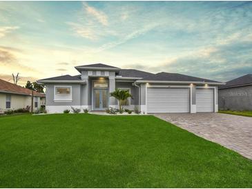 Attractive single-story home with three-car garage and well-manicured lawn at 287 Mariner Ln, Rotonda West, FL 33947