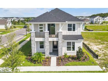 Two-story house with gray roof, light gray siding, and stone accents at 28801 Hillcrest Valley Blvd, Wesley Chapel, FL 33543