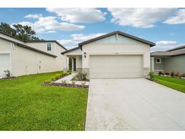 Front view of a single-story house with a two-car garage at 3810 Radiant Mountain Dr, Plant City, FL 33565