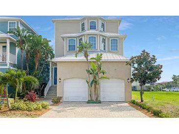 Three-story house with a two-car garage and landscaped front yard at 1340 Apollo Beach S Blvd, Apollo Beach, FL 33572