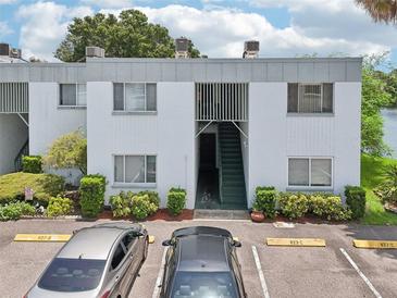 Exterior view of condo building with parking and landscaping at 811 N Keene Rd # V7, Clearwater, FL 33755