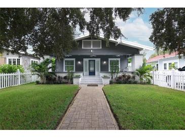 Charming bungalow with a gray exterior, white trim, and a landscaped front yard at 236 20Th Ave Se, St Petersburg, FL 33705