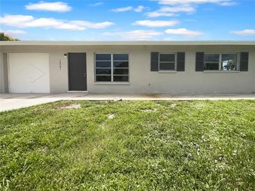 Ranch-style home with a one-car garage and well-maintained lawn at 12301 Veronese St, North Port, FL 34287