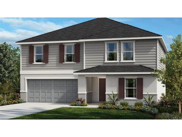 Two-story house with gray siding, dark brown shutters, and a three-car garage at 37457 Mackenzie Dr, Zephyrhills, FL 33540