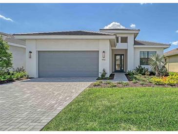 Charming single-story home with well-manicured lawn and a gray driveway, adding to its curb appeal at 4910 Carova Way, Lakewood Ranch, FL 34211