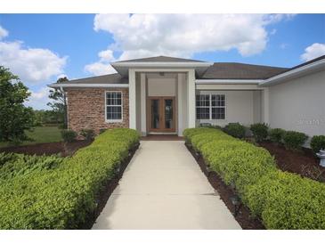 One-story house with stone accents and landscaped walkway at 7280 Verna Bethany Rd, Myakka City, FL 34251