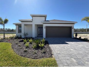 Charming single-story home with a neatly landscaped front yard and a two-car garage at 9613 Vibrant Lane, Venice, FL 34292